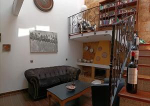 a living room with a couch and a table at La Casona Canaria Boutique Home B & B in Agüimes