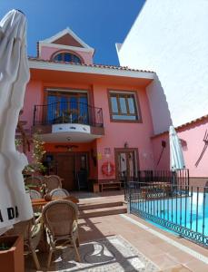 a house with a pool in front of it at La Casona Canaria Boutique Home B & B in Agüimes