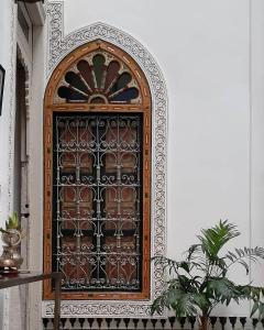 an ornate wooden door in a wall at Dar El Bali in Fez