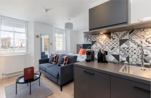 a kitchen and a living room with a couch at Destiny Scotland Market Street Apartments in Edinburgh