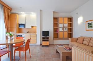 a living room with a couch and a table at Residence I Triangoli in Infernetto