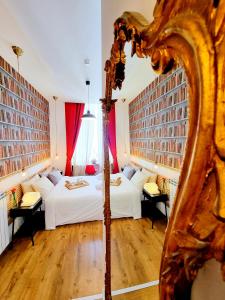 a bedroom with two beds and a mirror at Daily Napoli - Lungomare in Naples