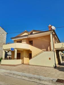 a large house with a garage in front of it at Apartment Manuel in Novigrad Istria