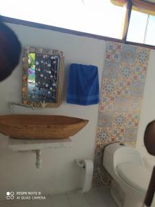 a bathroom with a wooden sink and a toilet at Los Versos de Zaira in San Onofre