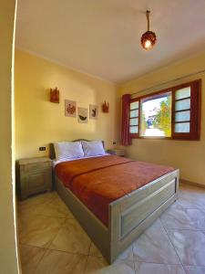 a bedroom with a bed and a window at Happy Land Hotel Dahab in Dahab