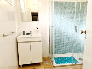 a white bathroom with a shower and a sink at Casas Algarvias in Arroteia de Baixo +89 photos