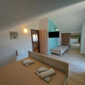 a bedroom with a bed and a living room at Apartments Batistić in Supetarska Draga
