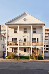 a white apartment building with a second floor balcony at Lankford Hotel and Lodge in Ocean City