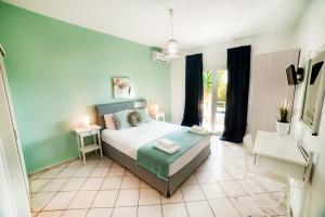 アイイ・アポストロにあるFilia Rooms & Apartmentsの青い壁のベッドルーム1室(ベッド1台付)