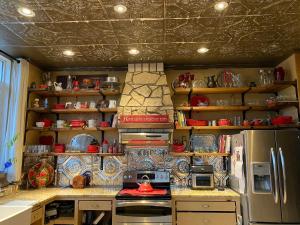 a kitchen with a stove and a refrigerator at The Old Church B&B in Warner