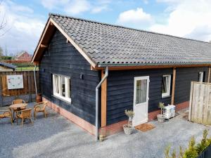 a black tiny house with a patio and a table at Stay America in America