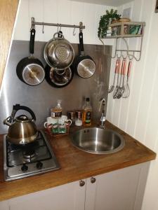 a kitchen counter with a sink and pots and pans at Ty bech twt in Machynlleth