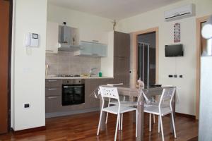 a kitchen with a table and chairs in a room at Porta Del Sole in Manfredonia