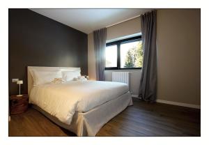 A bed or beds in a room at Il Rifugio del Risol