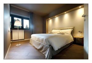 A bed or beds in a room at Il Rifugio del Risol