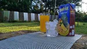 a drink and a box of cereal and a glass of orange juice at Kwetu Home - Sagana PAY BEFORE ARRIVAL in Sagana