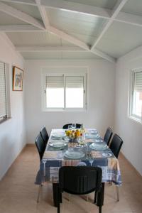 a dining room with a table with black chairs at Tamaide Paradise C in Costa Del Silencio