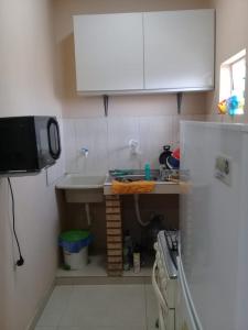 a small kitchen with a sink and a refrigerator at Ciudad del Este - Departamento amoblado in Ciudad del Este