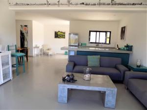 sala de estar con sofá y mesa en Green Goose self catering villa with pool, en Plettenberg Bay