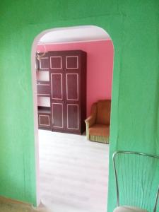 a door to a room with a couch and a chair at Мегацентр in Chernihiv