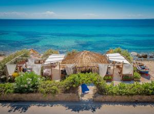 a group of tents on a beach near the ocean at Anastasia Miramar Deluxe Apartments in Zakynthos Town