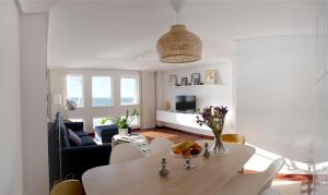 sala de estar con mesa y sofá en Apartamento Paseo Marítimo, en A Coruña