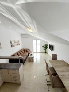 a living room with a couch and a table at Viktor in Herceg-Novi