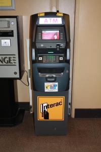 a atm machine with a sign on it at University of Alberta - Hotel in Edmonton