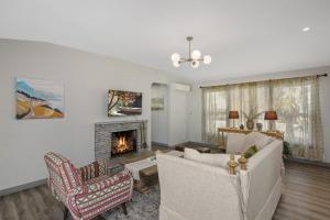 a living room with two chairs and a fireplace at @ Marbella Lane - 4BR Near Morongo Casino & Outlet Ldry+P in Banning