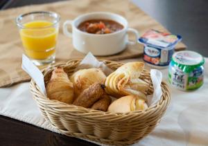 a basket of pastries and a cup of orange juice at Nagoya B's Hotel in Nagoya