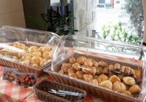 a table topped with baskets of bread and pastries at Nagoya B's Hotel in Nagoya