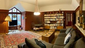 a living room with a couch and a table at l'Attique du Château in Cormondreche