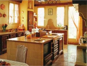 a large kitchen with an island in the middle at Ferme De La Canardière in Chantilly