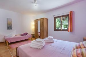 a room with two beds with white towels on them at Sa Vinyeta in Artá +19 photos