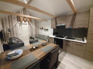 a kitchen with a wooden table in a room at Guesthouse 'Lodge Lagom' ~ Hammarstrand-Jämtland in Hammarstrand