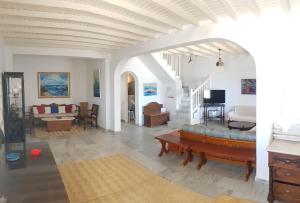 a living room with a couch and a table at 4BD Blue Dream Mykonos in Mikonos