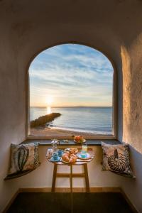 a table with a view of the ocean from a window at La Casa del Verricello - Sea view house in Meta