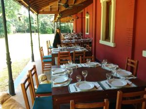 a table in a restaurant with two dogs sitting at it at Estancia La Dulce - Casa principal Casco in Roque Pérez