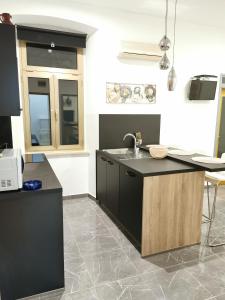 a kitchen with a sink and a counter top at Apartment Heart of Old Town in Pula