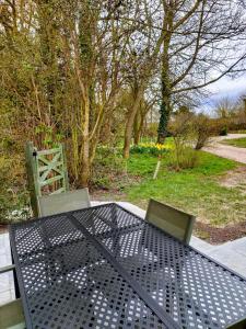 a metal table and chairs sitting on a patio at Covenham Holiday Cottages in Covenham