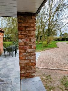 a brick pillar on a house with a patio at Covenham Holiday Cottages in Covenham