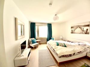 a bedroom with a bed and a tv in it at Zentral am See in Tegernsee in Tegernsee