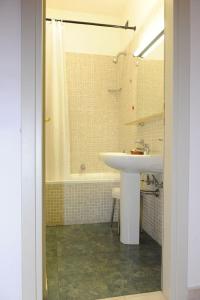 a bathroom with a sink and a shower and a tub at Hotel Villa Rosa in Martina Franca