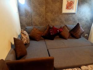 a couch with pillows on it in a room at Chalet Porto South Beach - Beach Front Sea View in Ain Sokhna