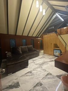 a living room with a couch and a fireplace at Noree Jacuzzi House in Ban Phan Sadet Nai