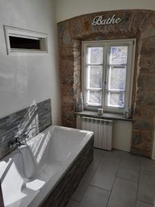 a large bath tub in a bathroom with a window at Villa Cascate in Bagnone