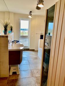 a bathroom with a sink and a window in it at Haus Meerruhe Karlshagen Apartment 1-6 in Karlshagen