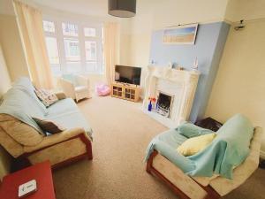 a living room with two couches and a fireplace at The Bays in Bridlington