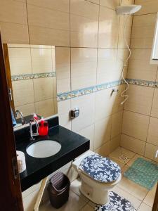 a bathroom with a sink and a toilet at Casa para temporada in Buriti