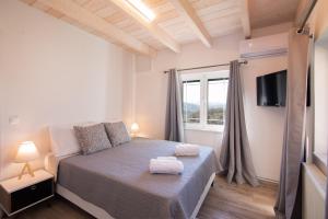 Ένα ή περισσότερα κρεβάτια σε δωμάτιο στο Sole di Corfu